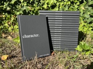 A stack of "character" signed by author Travis Knight